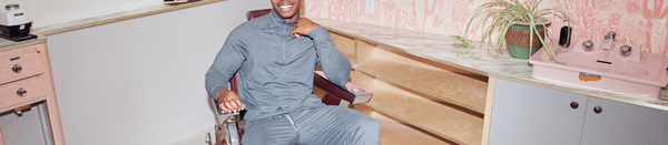 Man in grey sweatsuit sitting in barber chair