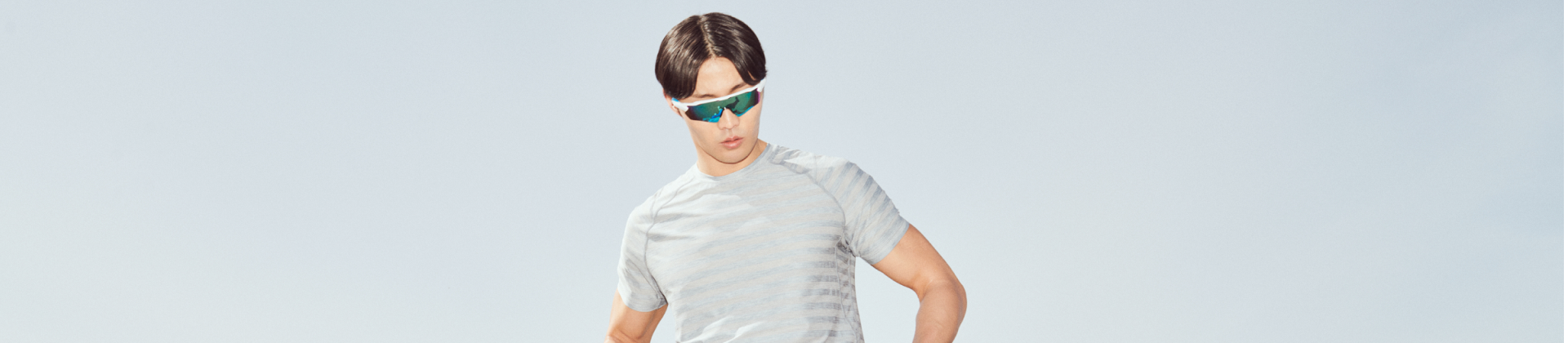 Man in striped tee and fast shades standing outside