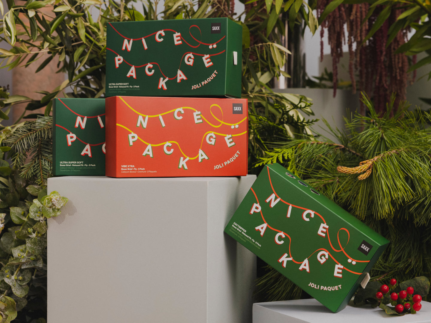 Four gift boxes on a white plinth. The boxes have white writing that says "Nice Package" on the front.