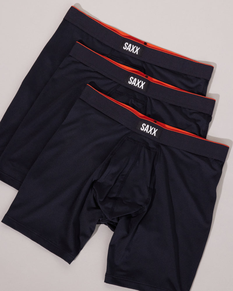 Three pairs of SAXX Performance Boxer Briefs laid out flat over white backdrop.