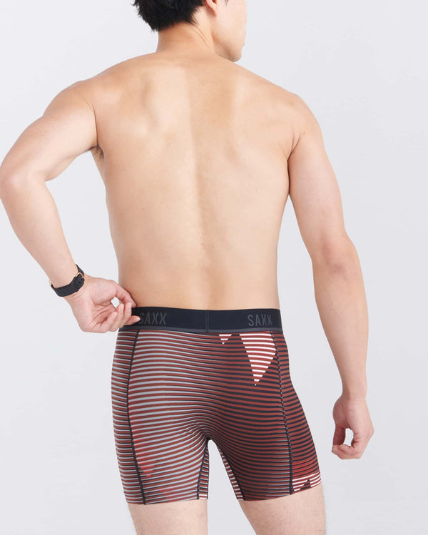 Back - Model wearing Kinetic Light-Compression Mesh Boxer Brief in Optic Mountain- Dark Brick