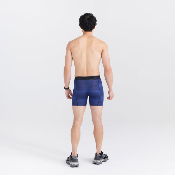 Back - Model wearing Kinetic Light-Compression Mesh Boxer Brief in Variegated Stripe- Blue