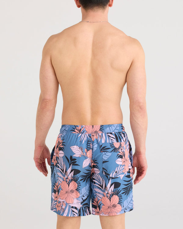 Back - Model wearing Oh Buoy 2N1 Swim Short in Hibiscus Jungle-Blue