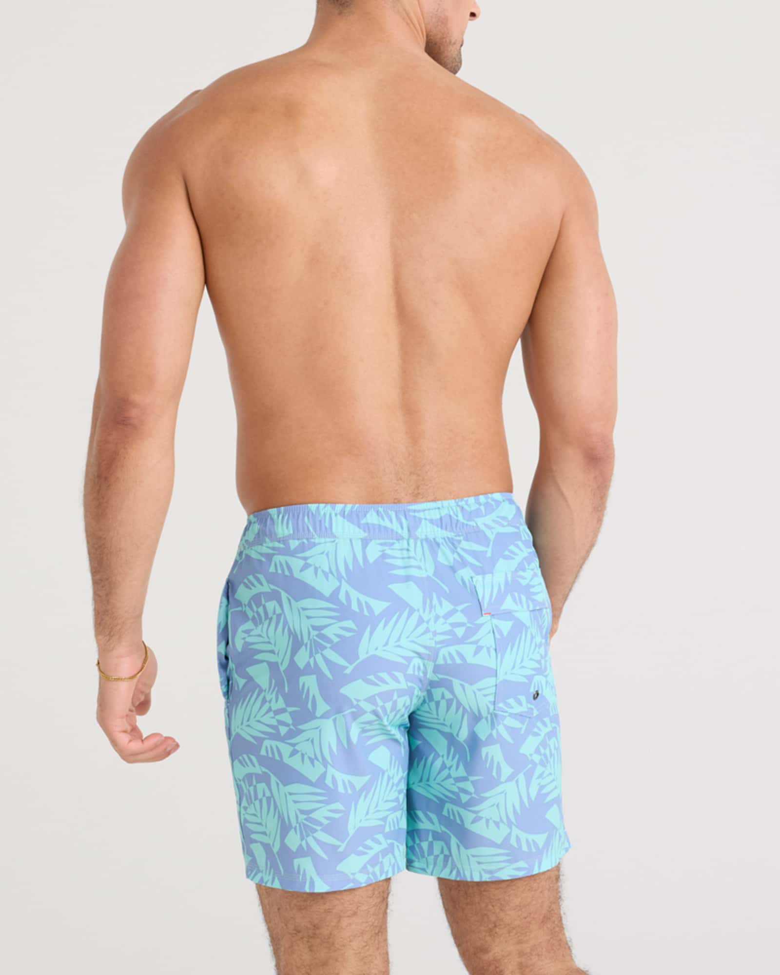 Back - Model wearing Oh Buoy 2N1 Swim Volley 7" in Palm Frond-Tidal Blue